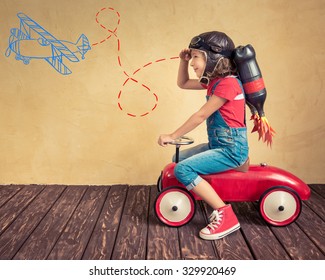 Kid With Jetpack Driving Retro Toy Car. Child Playing At Home. Success, Leader And Winner Concept