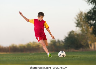 Kid Kicking Soccer Ball On Field Stock Photo 342076109 | Shutterstock