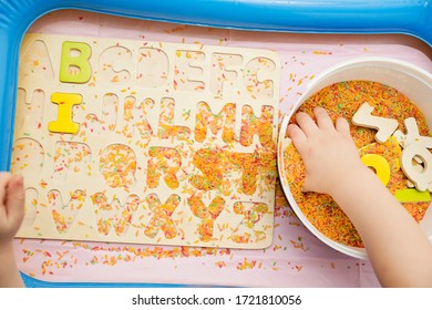 Kid Learning ABC's. Early Education For Toddlers With Colored Rice As Sensorial Elements. Therapy For Children With Easy Learning.