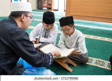 Kid Learning To Read Quran With Muslim Teacher Or Ustad