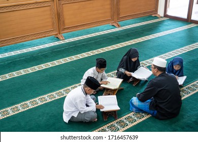 Kid Learning To Read Quran With Muslim Teacher Or Ustad