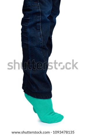 Kid legs in colored socks on leg isolated on white background.