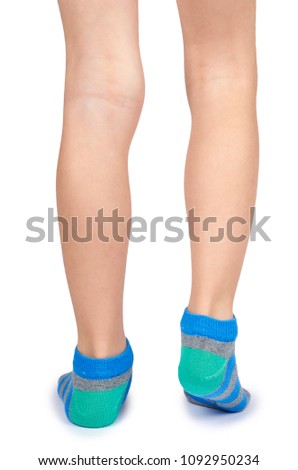 Kid legs in striped socks isolated on white background.