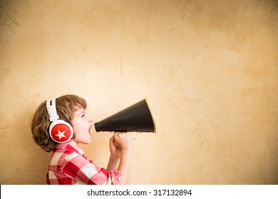 Kid listen music at home. Hipster child with retro vintage speaker - Powered by Shutterstock