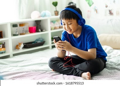 Kid Listening To Music On Bed At Bedroom For Relax