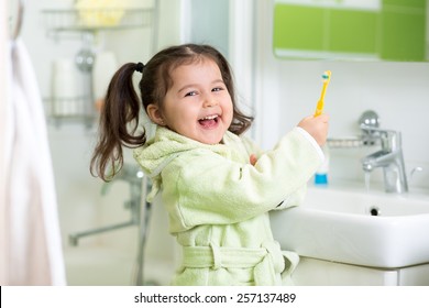 Kid Little Girl Brushing Teeth In Bath