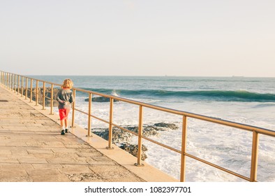 Kid looking at the big waves