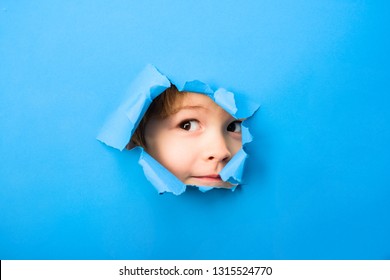 Kid Looking Through Paper. Spy Eye Watching Through Hole. Child's Eye Looking Through Hole. Boy Breaks Paper. Through Paper. Sale. Discount.