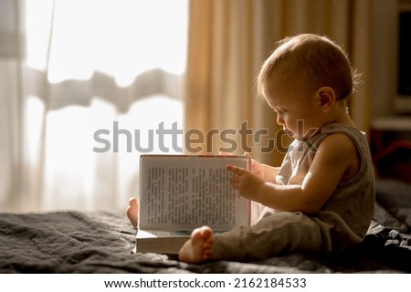 Similar – young caucasian little boy playing with tablet on couch