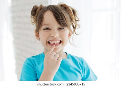 The kid lost a tooth. Baby without a tooth. Portrait of a little girl no tooth. High quality photo - Shutterstock ID 2145885715
