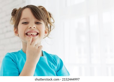 The kid lost a tooth. Baby without a tooth. Portrait of a little girl no tooth. High quality photo - Shutterstock ID 2152444997