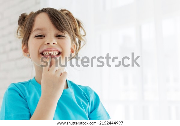 The kid lost a tooth. Baby
without a tooth. Portrait of a little girl no tooth. High quality
photo