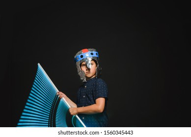 The Kid With A Makeshift Helmet And With A Neon Lamp In His Hands, As If With A Lightsaber, Emotionally Depicts The Battle Of A Superhero.