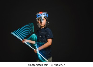 The Kid With A Makeshift Helmet And With A Neon Lamp In His Hands, As If With A Lightsaber, Emotionally Depicts The Battle Of A Superhero.