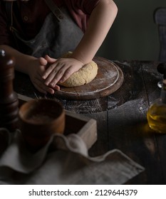 Kid Making Dough On Wooden Table With Ingredients Flour, Oil, Salt, Dark Background. Copy Space. Home Bakery Concept, Kitchen Cooking Story.