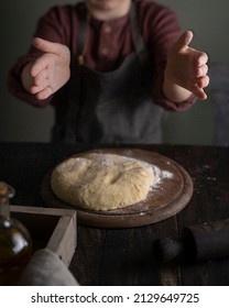 Kid Making Dough On Wooden Table With Ingredients Flour, Oil, Salt, Dark Background. Copy Space. Home Bakery Concept, Kitchen Cooking Story.