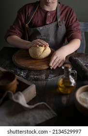 Kid Making Dough On Wooden Table With Ingredients Flour, Oil, Salt, Dark Background. Copy Space. Home Bakery Concept, Kitchen Cooking Story.