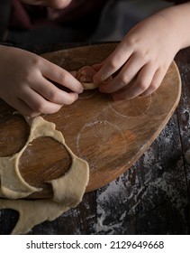 Kid Making Pelmeni (meet Dumplings) Of Dough On Wooden Table With Ingredients Flour, Oil, Salt, Dark Background. Copy Space. Home Bakery Concept, Kitchen Cooking Story.