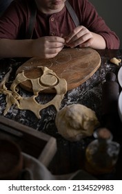 Kid Making Pelmeni (meet Dumplings) Of Dough On Wooden Table With Ingredients Flour, Oil, Salt, Dark Background. Copy Space. Home Bakery Concept, Kitchen Cooking Story.