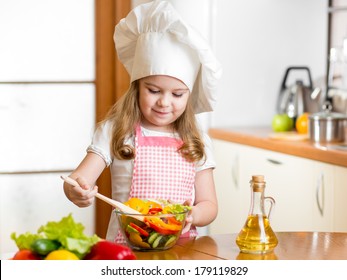 Kid Making Salad At Kitchen