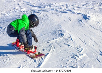 Kid On Snowboard In Winter Sunset Nature. Sport Photo With Edit Space