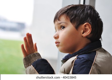 A kid on the window waiting