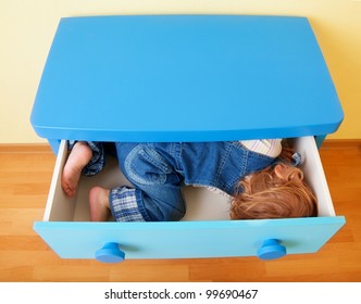 Kid In The Open Box Of Cabinet