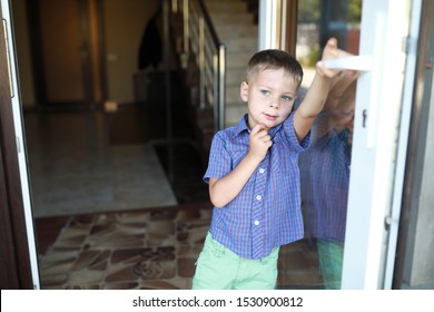 Kid Opening Mirrored Front Door At Hotel