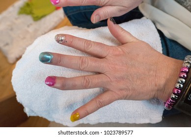 Kid Painting Nails On A Adult