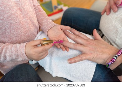 Kid Painting Nails On A Adult