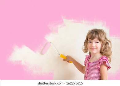 Kid Painting Wall With Pink Color. Renovation Concept