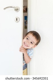 Kid Peeking Out Of The Open Room Door