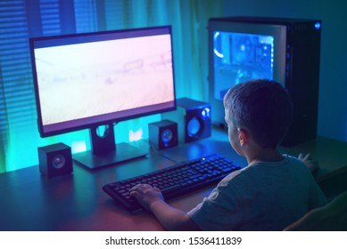 Kid playgame on gaming PC. Concept of growth gaming industry and the mental development of young people.