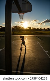 Kid Playing Basketball Silhouette On Sunset. Basket Ball Kids School.