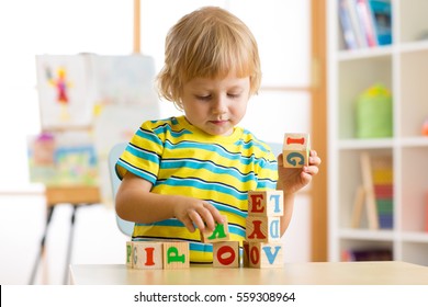 kid playing with block toys and learning letters