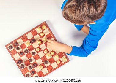 Kid Playing Chess Game On Chessboard. Top View