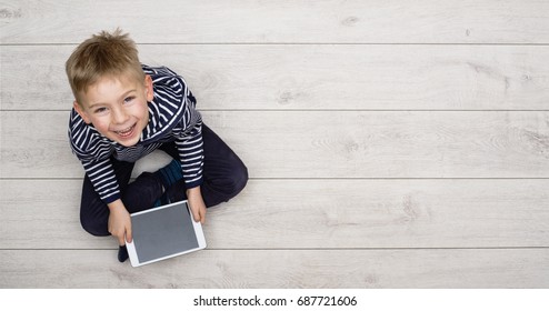 Kid Playing With His Tablet Pc