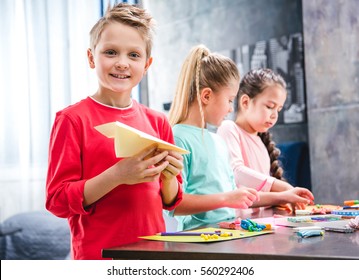 Kid Playing With Paper Plane, Schoolchildren Molding Colorful Plasticine