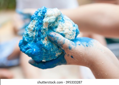 Kid Playing With Pasta Dough Painted Blue