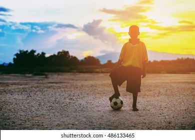 Kid Is Playing Soccer Football For Exercise Under The Sunlight.