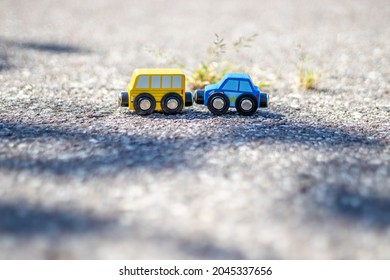 A Kid Is Playing With Some Wooden Cars, United Like A Train,magnet Connections,on The Asphalt, Outside. Concept: Playing Outdoor, Summertime, Eco Toys. Police Car, Bus