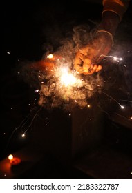 A Kid Playing With A Sparkler On Diwali 