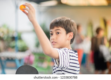 Kid Playing Table Tennis Outdoor With Family