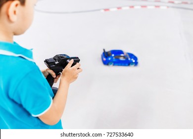 Kid Playing With A Toy Car With Wireless Radio Remote Control