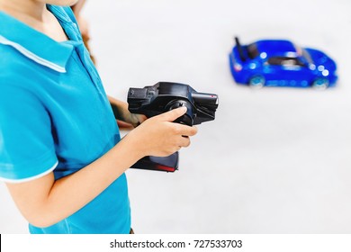 Kid Playing With A Toy Car With Wireless Radio Remote Control
