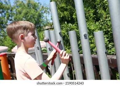 Kid Playing Xylophone In Park In Summer