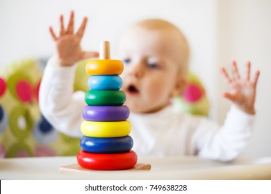 The Kid Plays The Pyramid. Child Playing With Wooden Toys