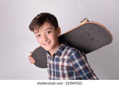 Kid Portrait Holding Skateboard Studio Portrait.