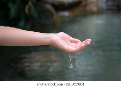 Kid Pouring Water From Hand In Pond, Closeup