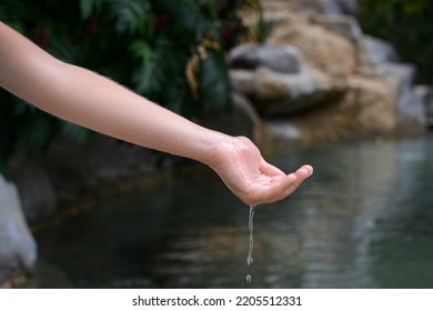 Kid Pouring Water From Hand In Pond, Closeup